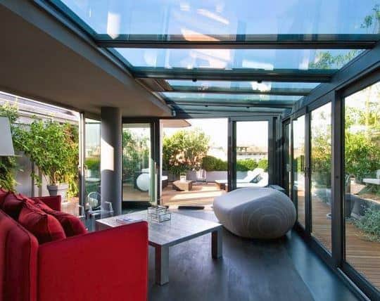 glass roof sunroom wood floors red couch