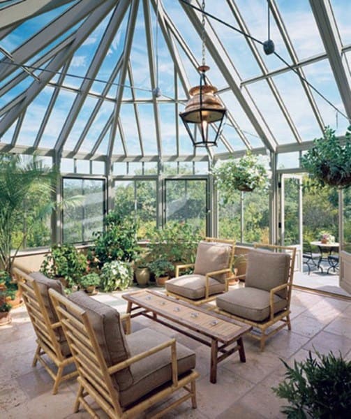 high ceiling sunroom with lots of plants