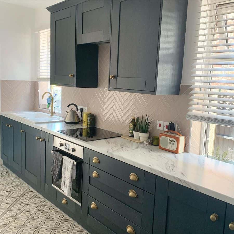 gray cabinets in modern kitchen with white subway tile splashback 