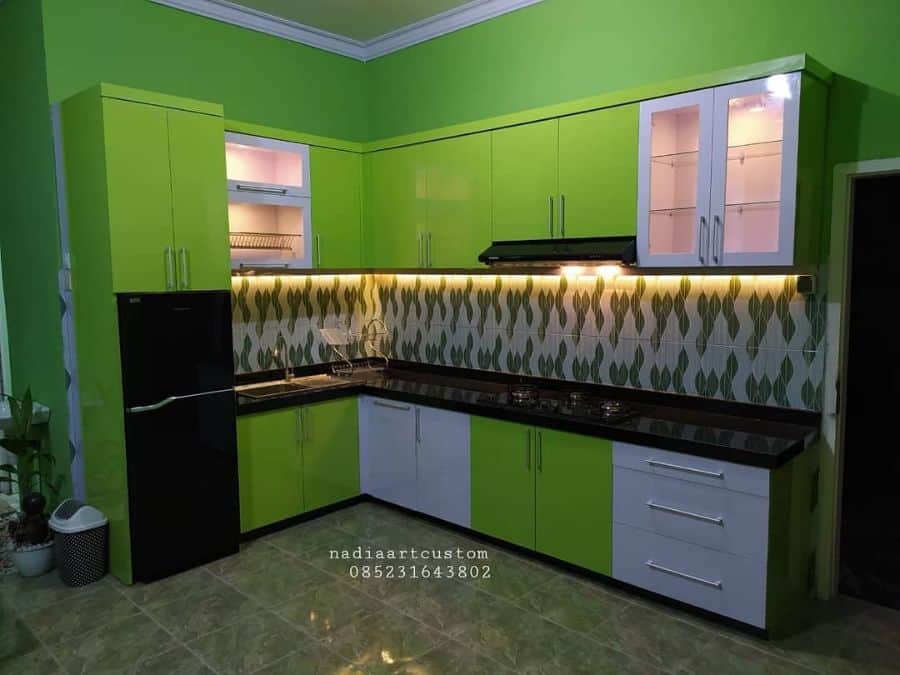 green cabinet kitchen with black countertop 