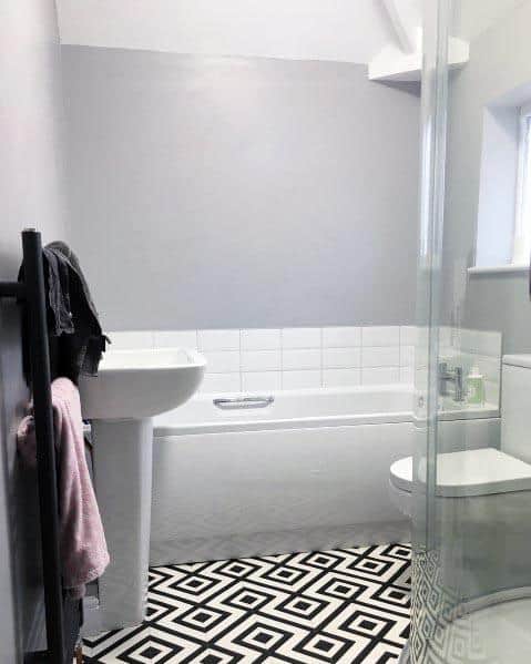 simple small master bathroom with black and white pattern tile floor
