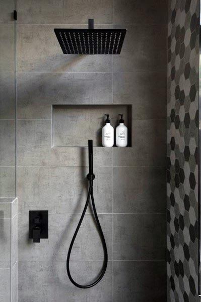 minimalist gray tile shower with recessed shelf and black accents 