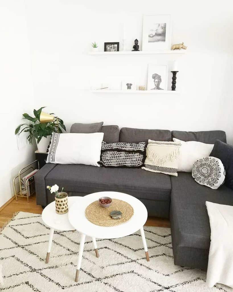 small living room gray sofa white coffee table wall shelves 