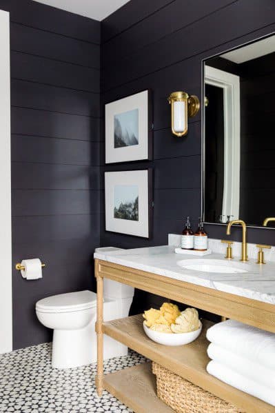 black shiplap walls in modern bathroom with marble top vanity
