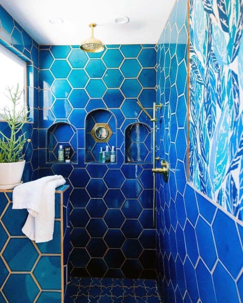 blue tile bathroom with gold accents 