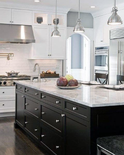 country kitchen with white and black cabinets marble countertop and silver pendant lights 