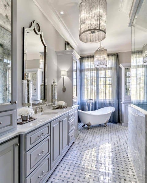 impressive master bathroom with gray vanity and double chandeliers