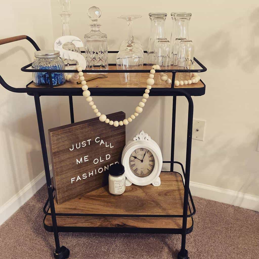 wooden bar cart with glasses