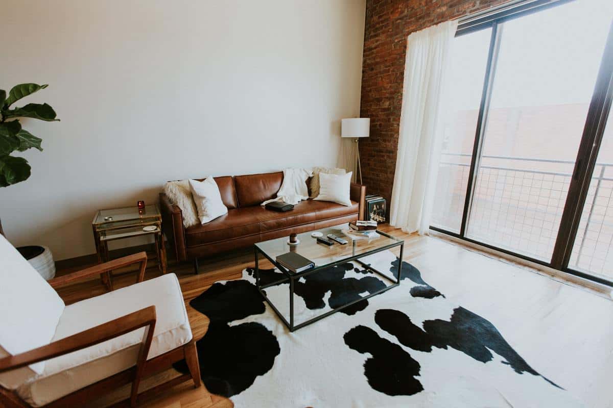 living room brown couch cowhide floor rug