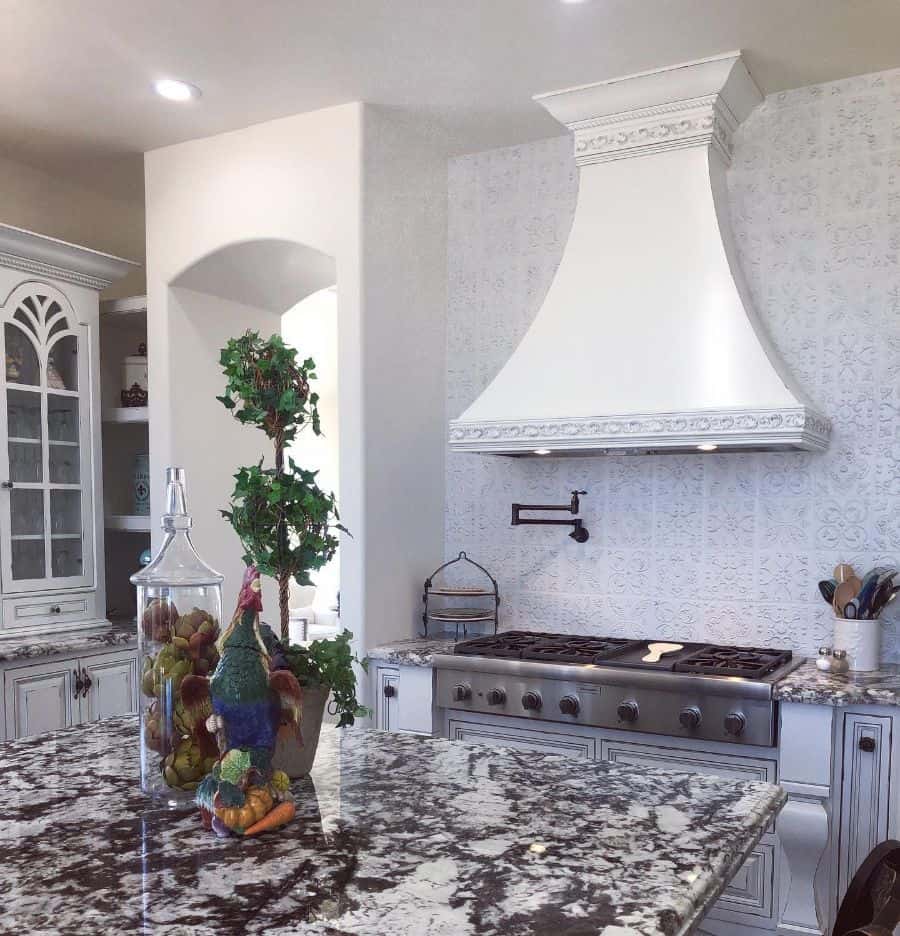 ornamental white kitchen hood tile wall marble countertops 