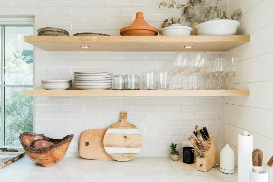 simple floating wood shelves with led lighting holding glassware and plates