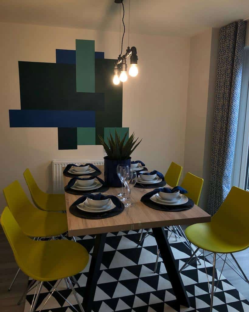 abstract dining room wall art dining table yellow chairs pendant lights 