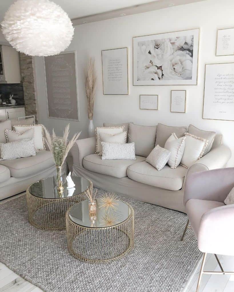 light white living room gray sofa gold framed artwork glass coffee tables 