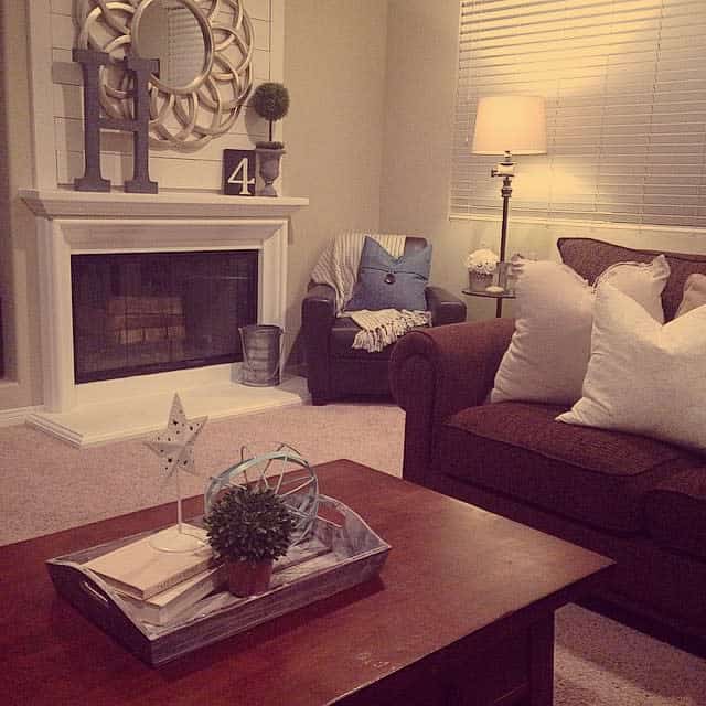 living room white wood shiplap fireplace brown coffee table 