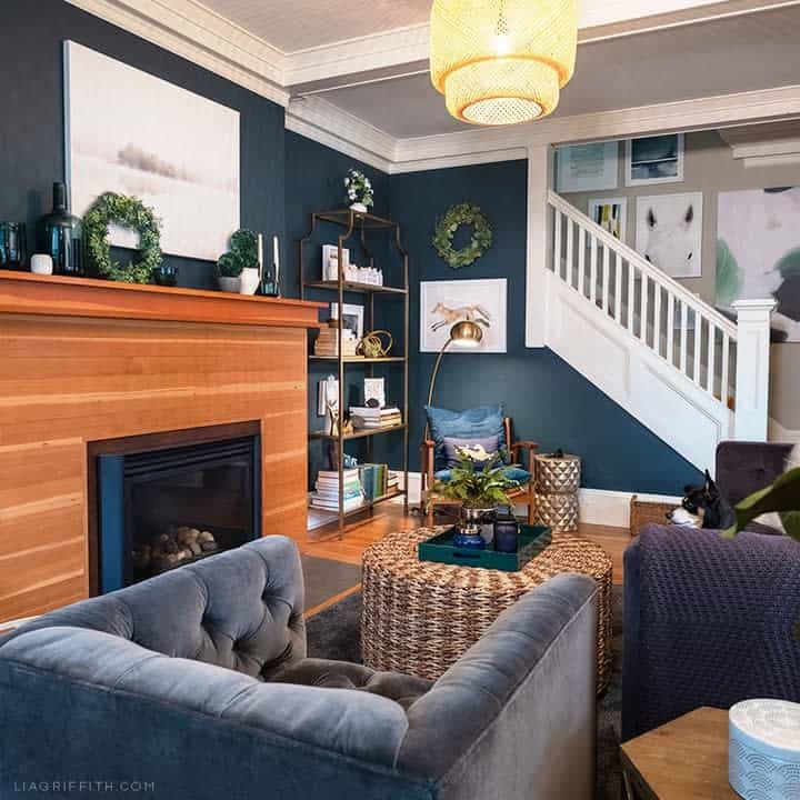blue living room wood fireplace wall blue sofas 