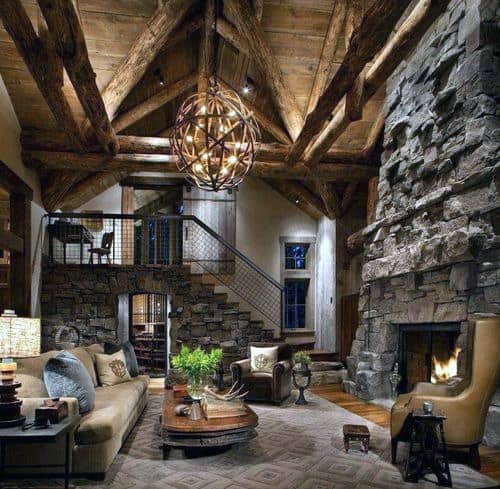 rustic cabin style living room with stone walls and fireplace 