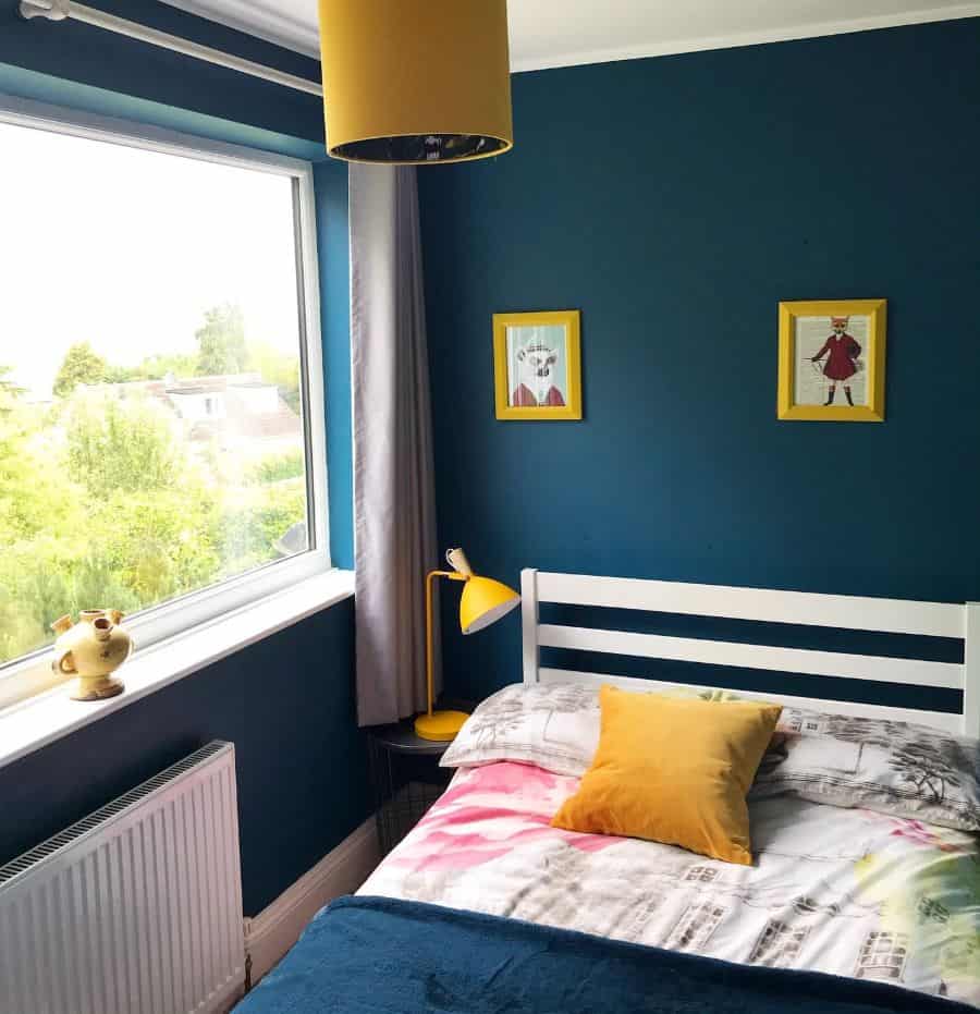 modern green bedroom framed wall art yellow lamp view