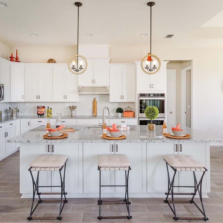 luxury kitchen white cabinets pendant lights granite countertop tile floor 