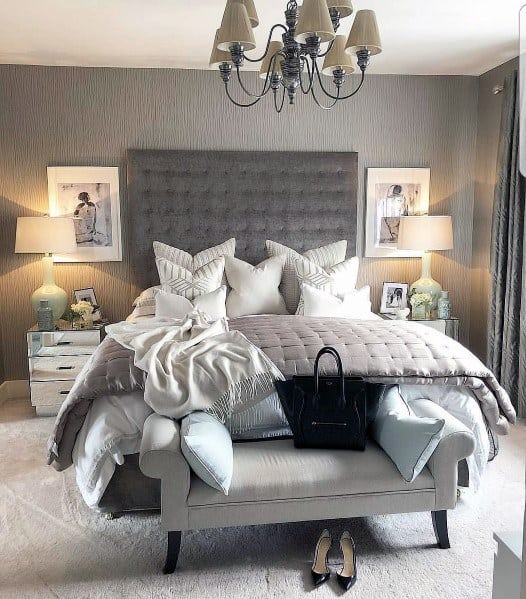 gray small master bedroom with ottoman 