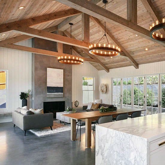 country style living room with wood ceiling and slate floors