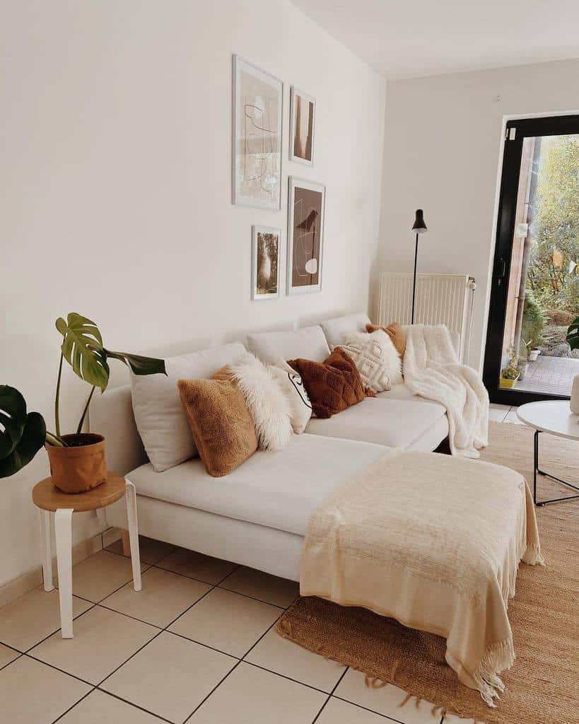 minimalist beige color living room sofa pot plant framed wall art black floor lamp 