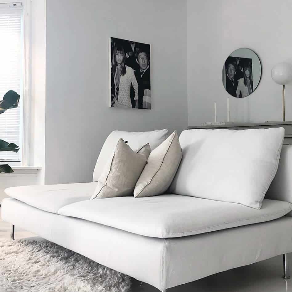 small gray sofa white floor rug photo wall art