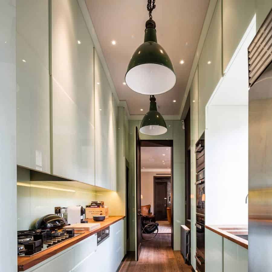 narrow gallery kitchen with green cabinets 