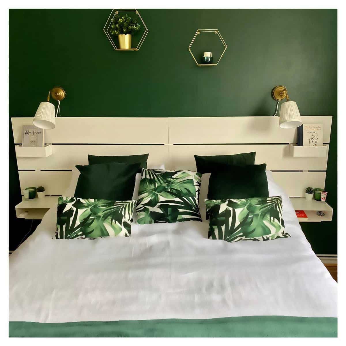modern bedroom green feature wall wood panel bed frame sconces lights