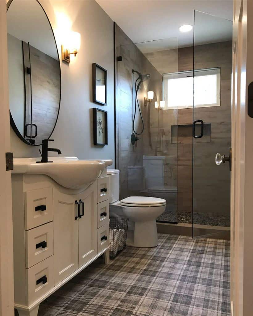 narrow bathroom with white cabinets and glass shower 