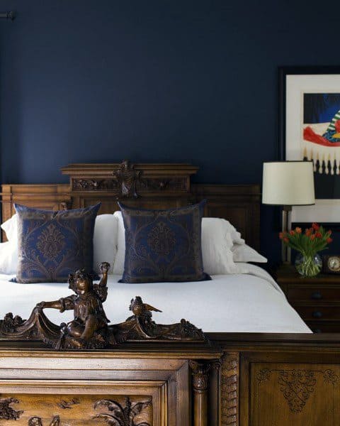 blue wall bedroom ornate wood bed