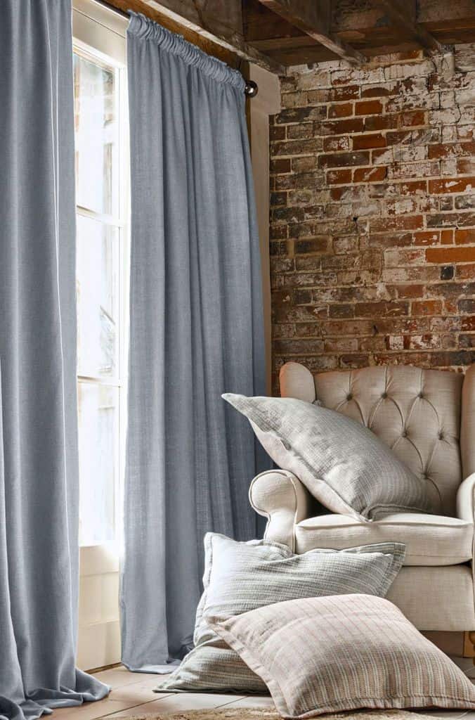 exposed brick wall navy curtains living room
