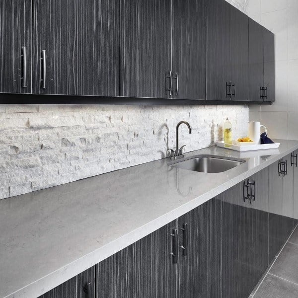 gray kitchen cabinets and white brick splashback
