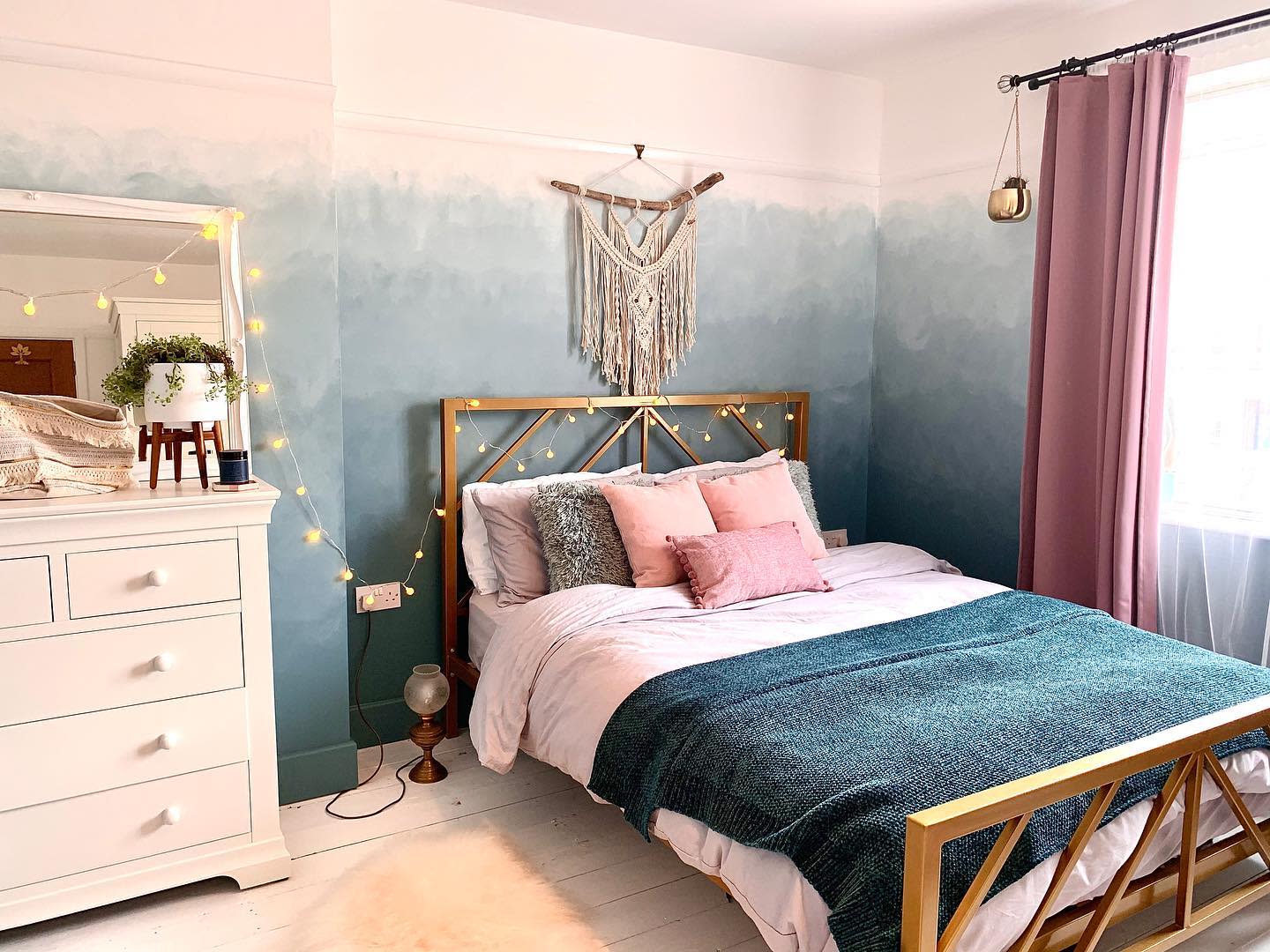 blue ombre wall painting pink curtains wood bed frame white cabinet bedroom 