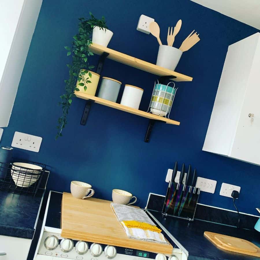 blue accent wall wood floating shelves small kitchen 