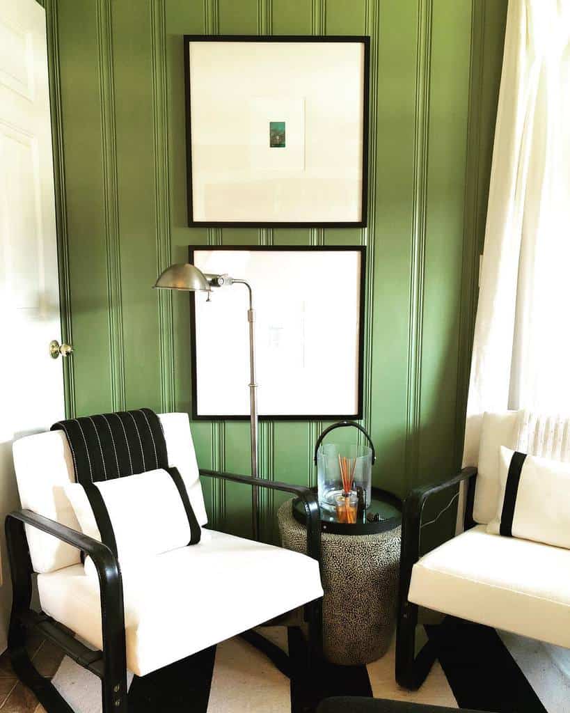 green painted wall paneling white sofas 