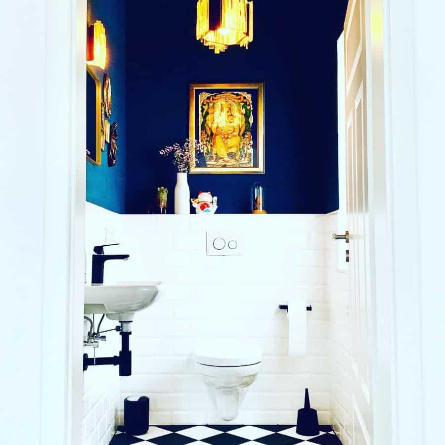 elegant powder room with white tiles and blue wall 