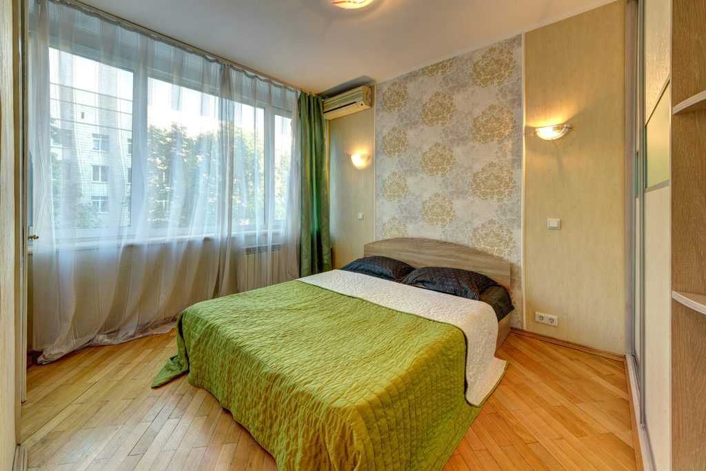 floral print bedroom wallpaper wood flooring green bed