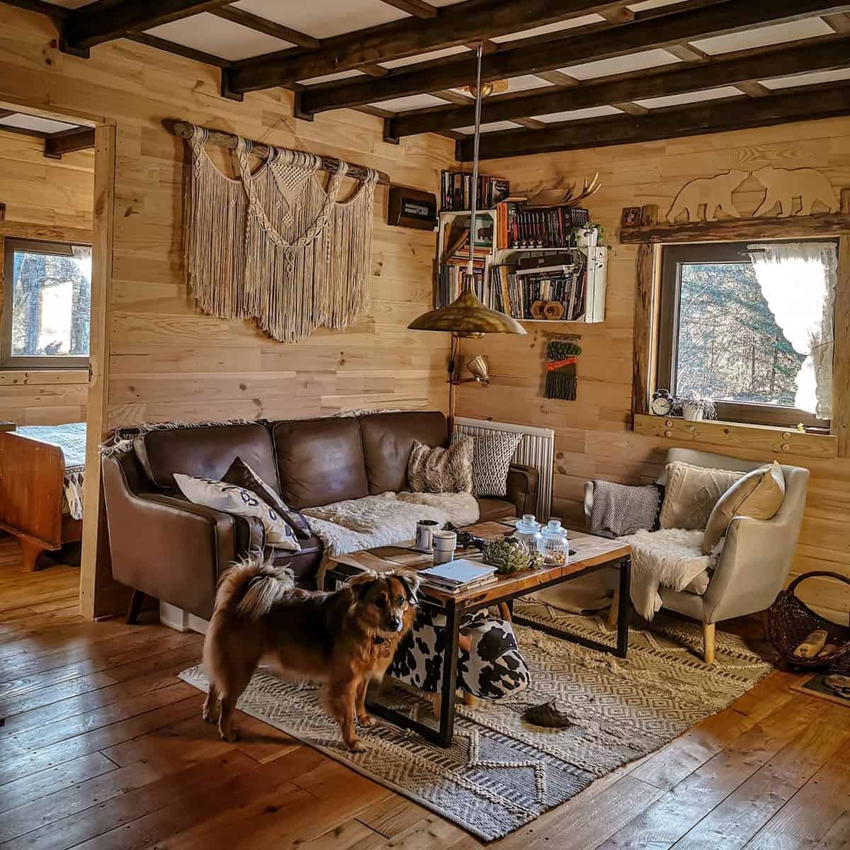 wood cabin small living room brown sofa dog