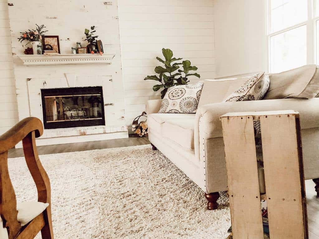 white shiplap wall living room fireplace sofa 