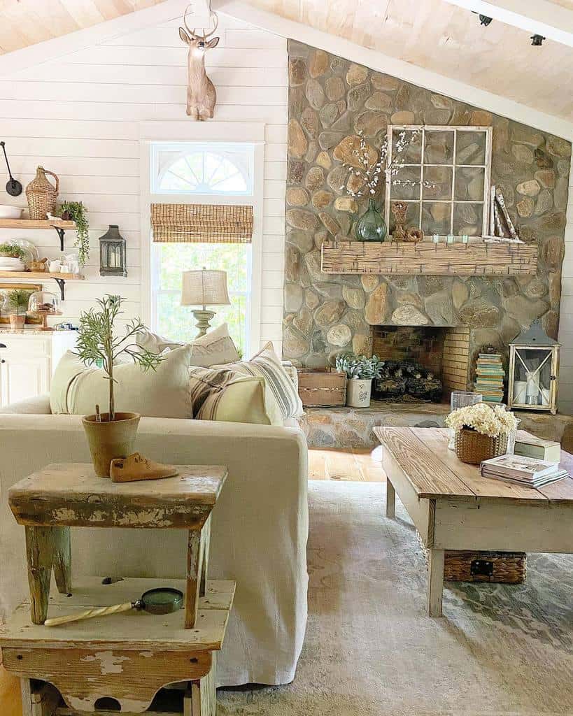 rustic living room stone fireplace shiplap walls sofa and coffee table 