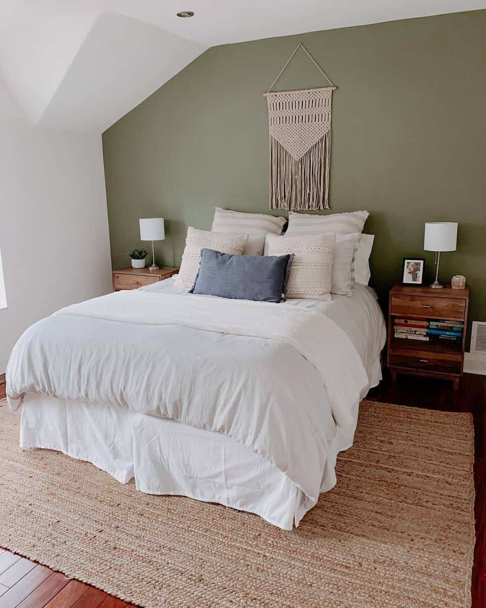 attic bedroom green feature wall wood bedside tables 