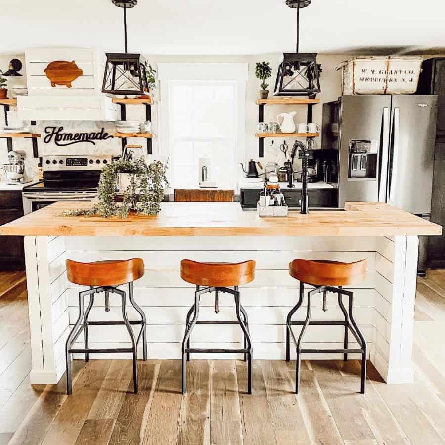 rustic kitchen white panel wood bar with varnished wood countertop three stools 