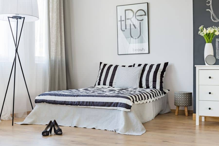scandinavian bedroom platform bed white cabinet vinyl wood floors 