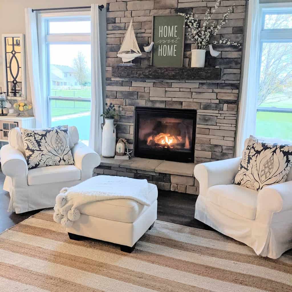 country living room stone fireplace white lounge chairs 