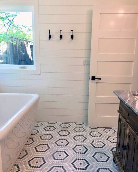 country bathroom with shiplap walls and freestanding tub 