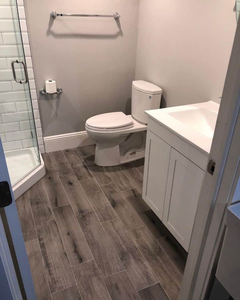 laminate wood floor in small white bathroom
