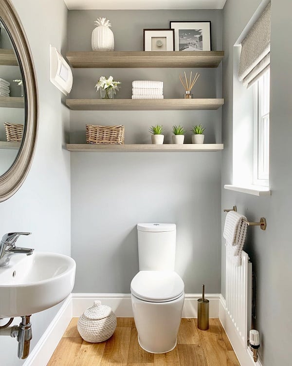 small modern powder room with wall shelves 