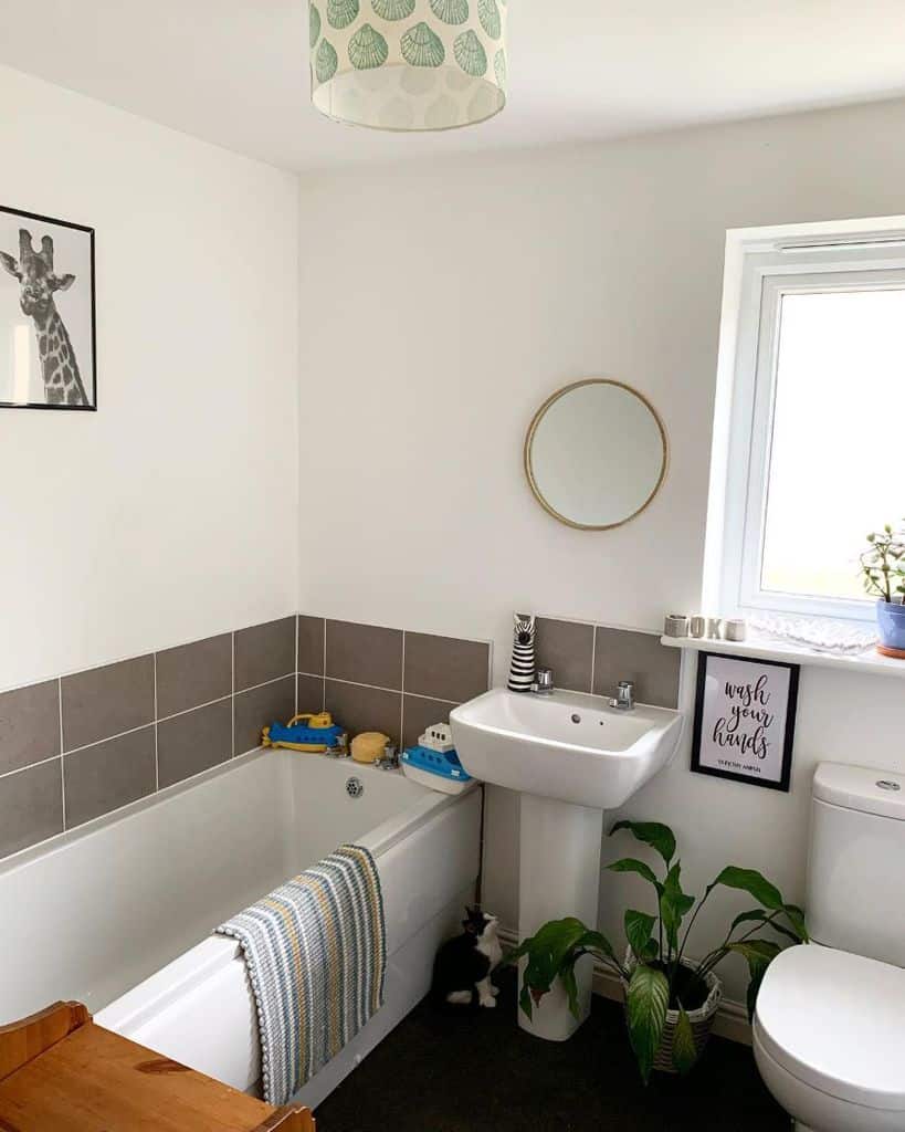 large simple bathroom with tub and floor plant 