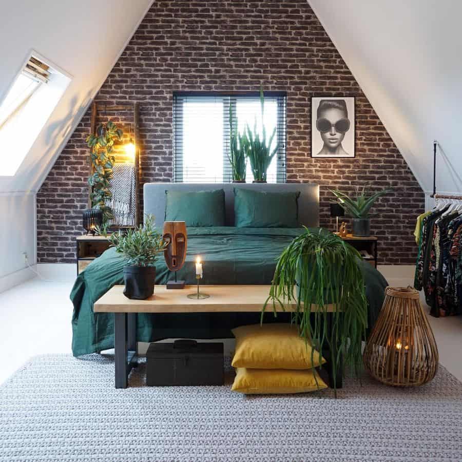 vintage attic bedroom with brick accent wall and green bed