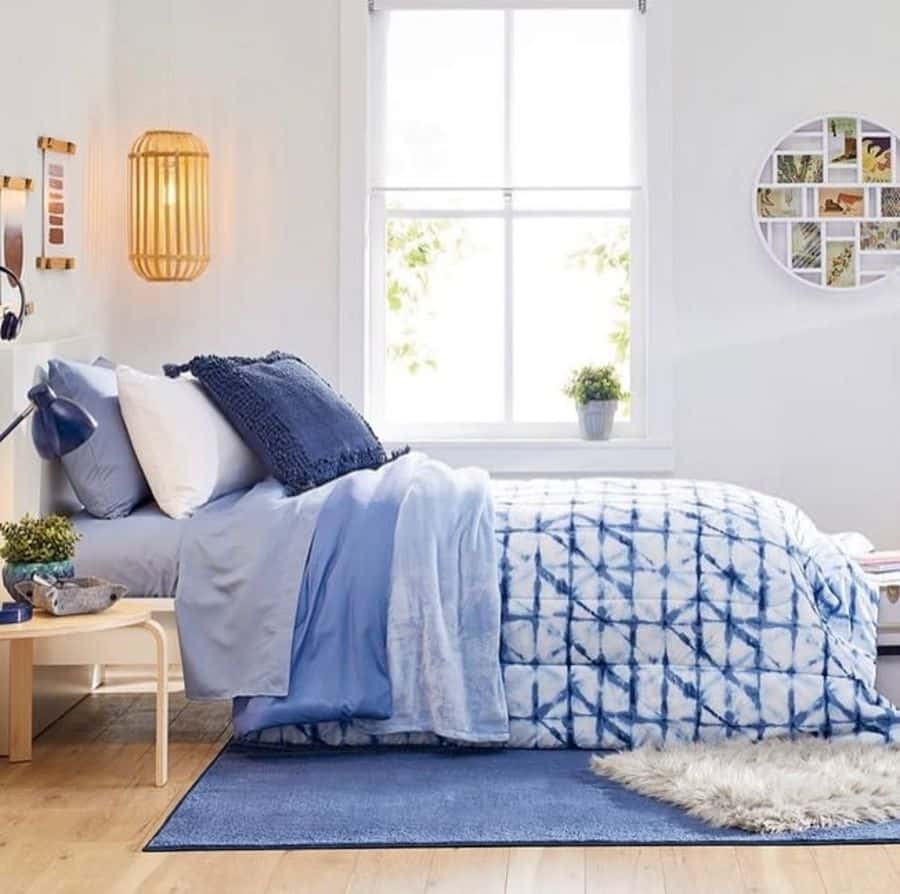 blue bed in small white bedroom 